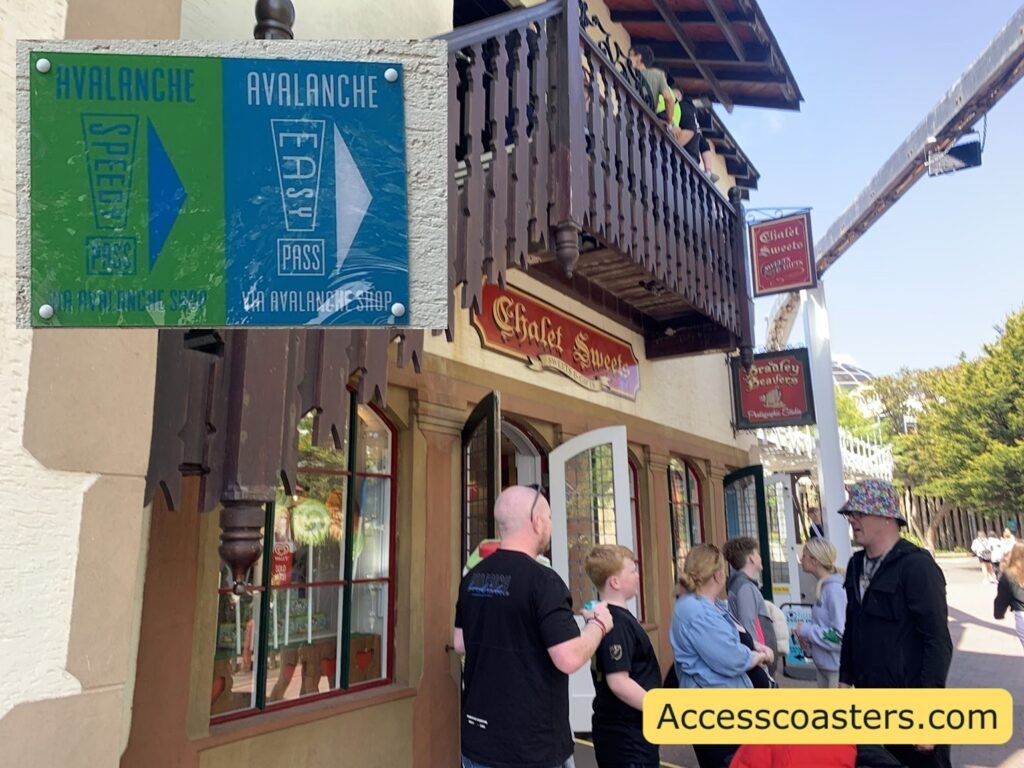Entrance to the Avalanche roller coaster easy access route at Blackpool Pleasure Beach, showing the exterior of the themed gift shop and signage that reads easy access pass and speedy pass entrance