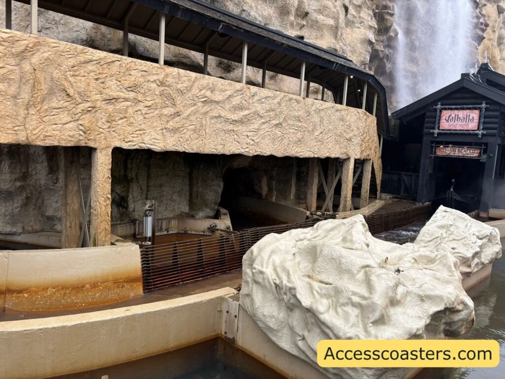 outdoor section of the boat ride water visible in the ride  beneath a wooden, Viking‑style structure