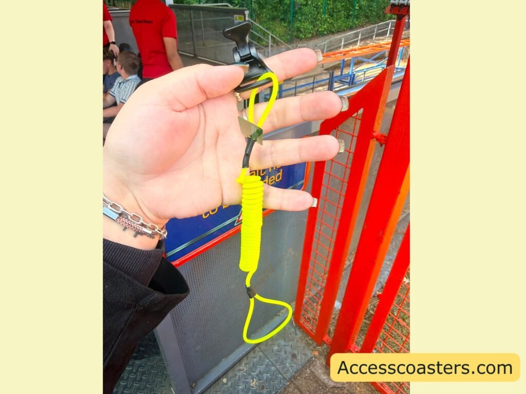 image of yellow ear defender teather with yellow loop at the bottom attached to yellow extendable strap wit a black clip on top