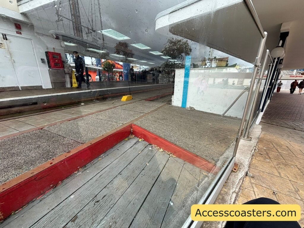 Close view of the wheelchair entrance path alongside the Grand National station, showing a smooth raised platform beside the track.
