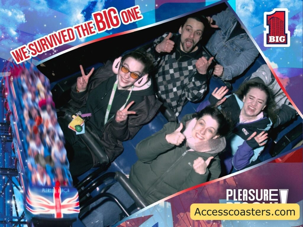 On‑ride photo showing four riders seated in the Big One train at the start of the drop, framed with the words “We Survived The Big One,”