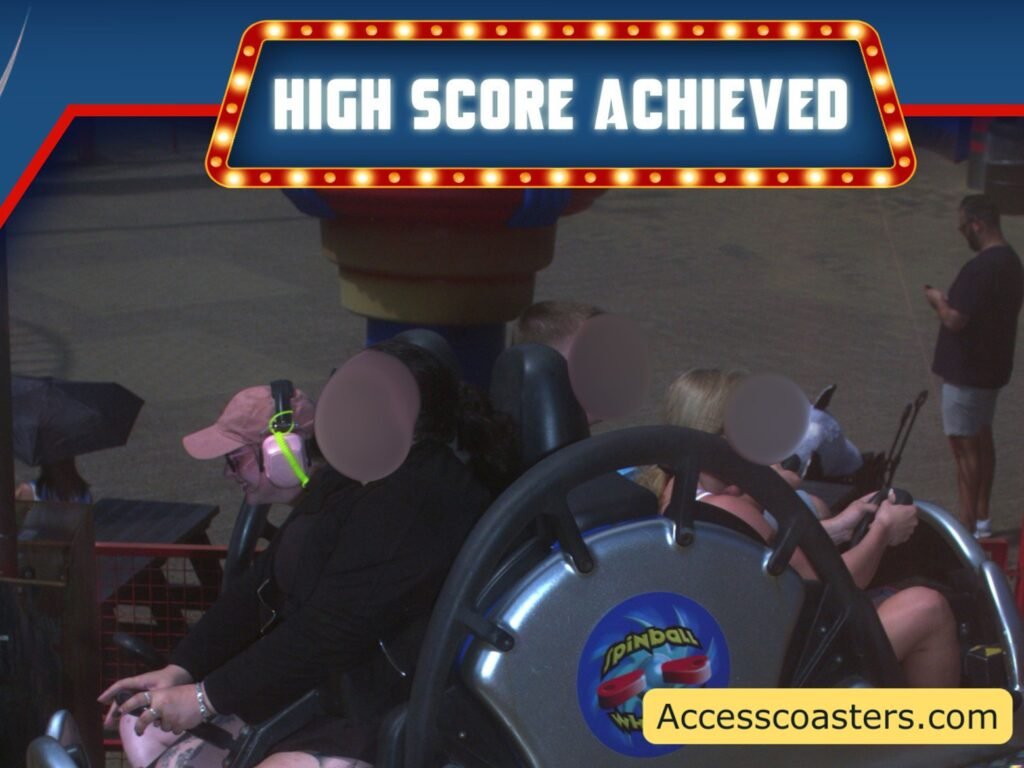 spinnballl on ride photo all other people then iona have there faces blurred and you can see iona smiling with the yellow ear defender teather visible attached to her ear defenders