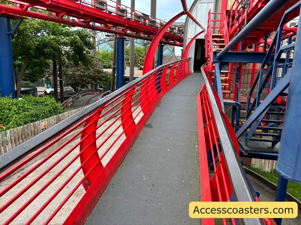 Step-free outdoor ramp beside the Big One’s bright red track and supports