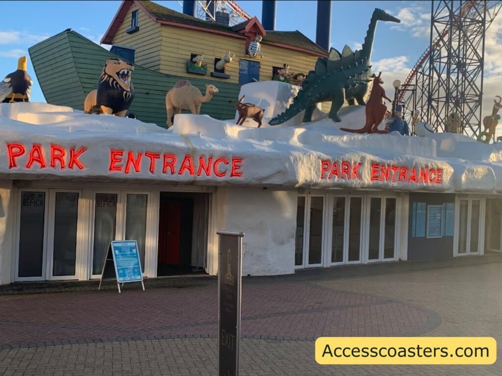 entrance into plesure beach theme park you can see front of a white building with lots of doors and red wording that reads park entrance noah arch on top of the building