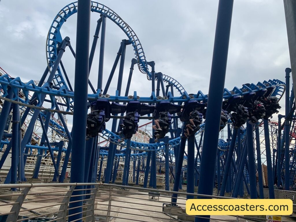 close up image of infution twist on track with train full of rides you can see more of the blue track in the background with invertion visable 