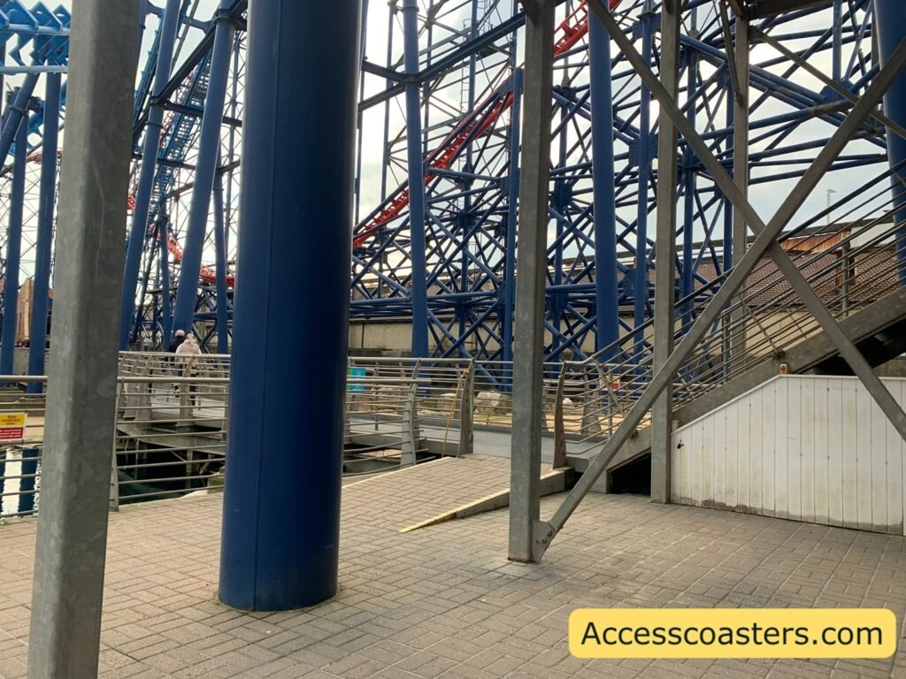 paved area and ramp nder the coaster structure leading up to the easy access and speed pass entrance gate