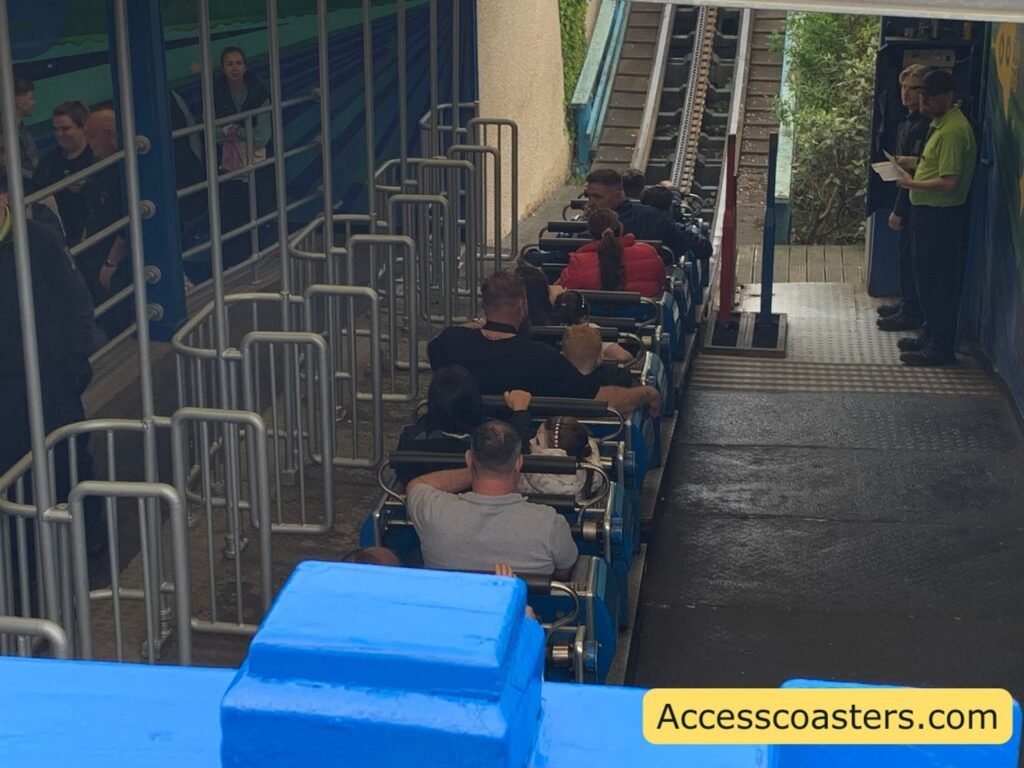 birds eye view of blue flyer station you can see rides air gates and a full train of ridders 