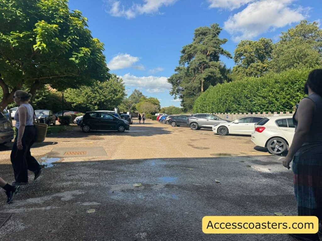 image if gravel car park with lots of rows of parked cars 