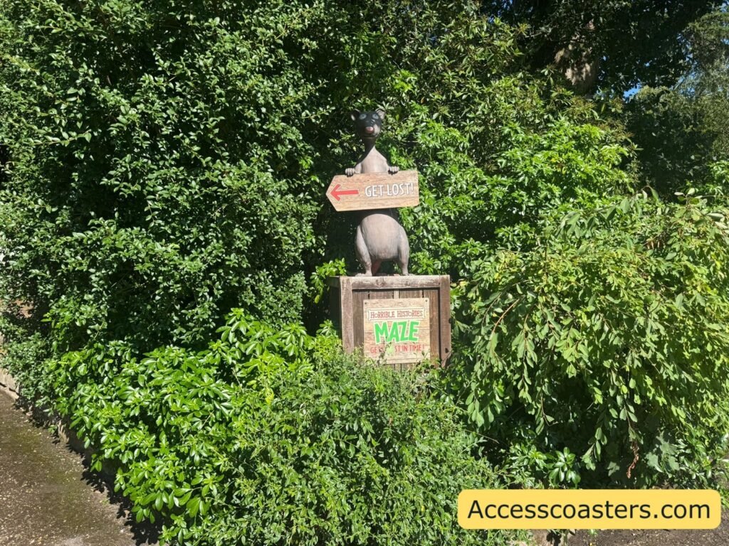 a sign with a horrible history character on with a directional arrow that says get lost. 