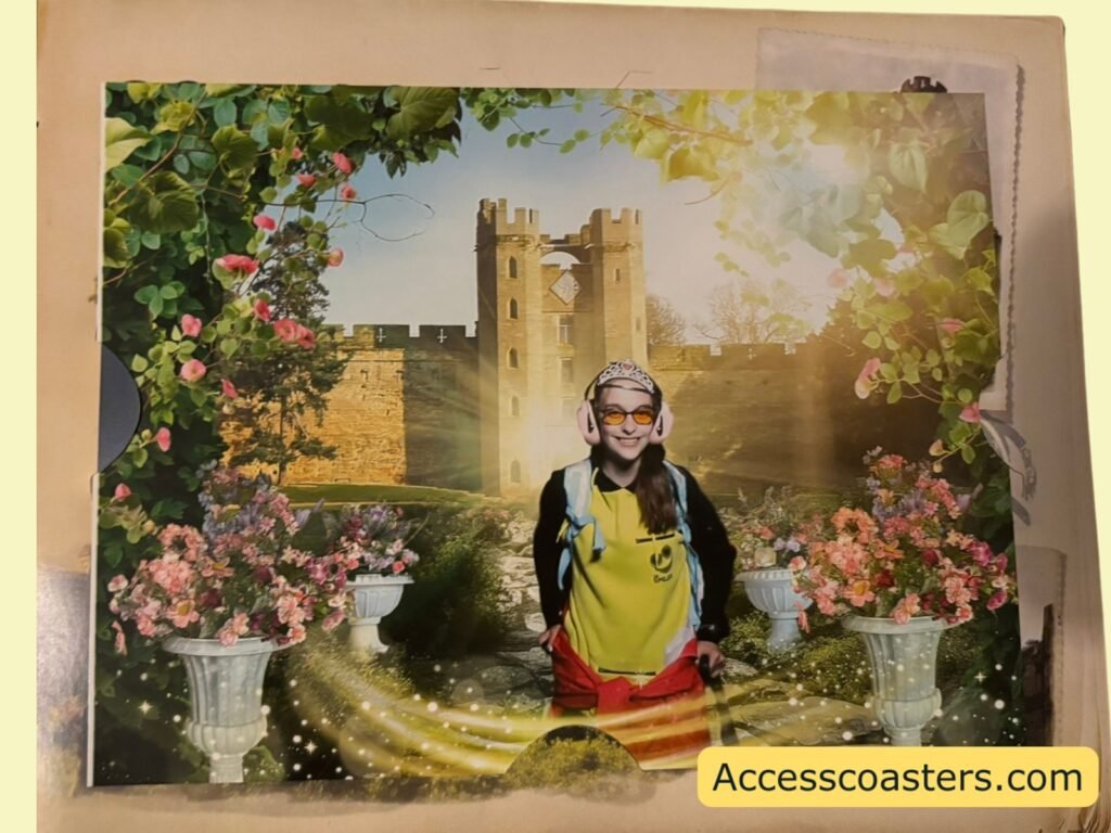 image if Iona stood smiling and wearing a princess crown in front of a green screen drop back of a princess themed Warwick castle. 